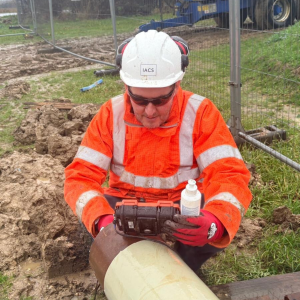 A front-on image of Terry Rush, Multi-Disciplined Inspector, carrying out a test on a pipeline.