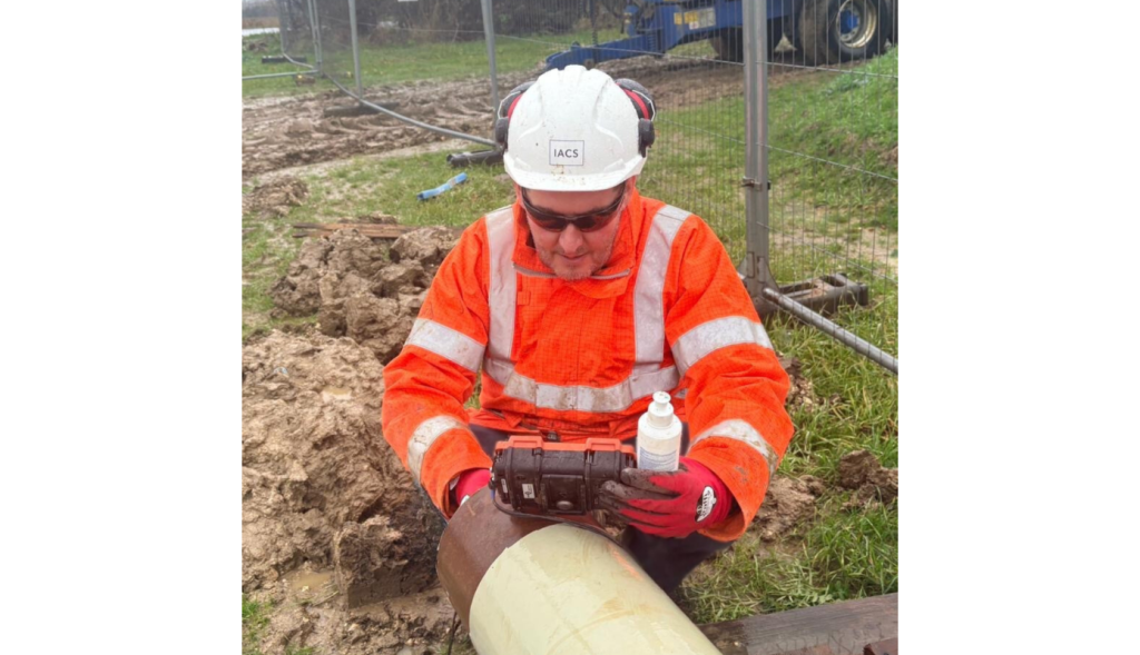 A front-on image of Terry Rush, Multi-Disciplined Inspector, carrying out a test on a pipeline.