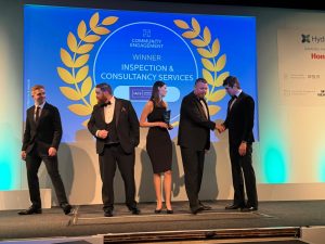 An on-stage image of the team receiving the Community Engagement Award at the Hydrogen Uk Awards.